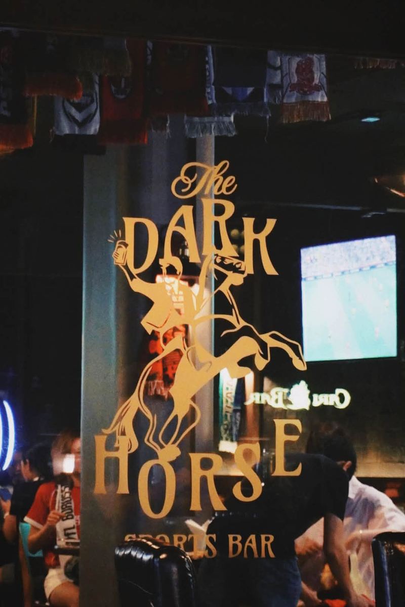 The Dark Horse logo on the window with a match on TV